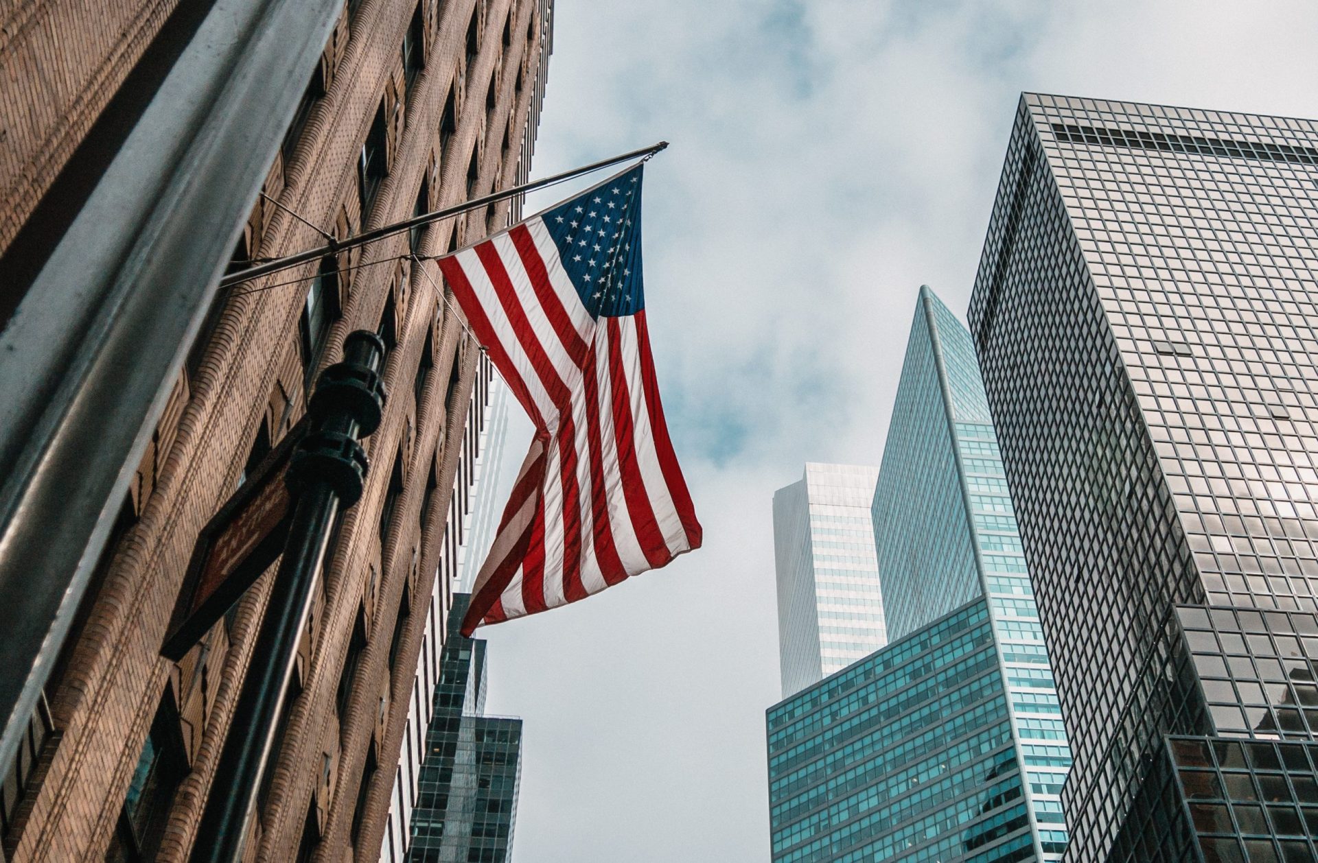 https://localitco.com/wp-content/uploads/2024/07/usa-united-states-america-flag-flagpole-near-skyscrapers-cloudy-sky-scaled-e1724153866380.jpg